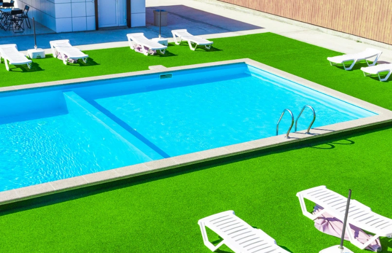 Artificial turf installed beside a swimming pool in a Dallas backyard
